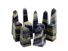 Set of striped crystal obelisks on a white background