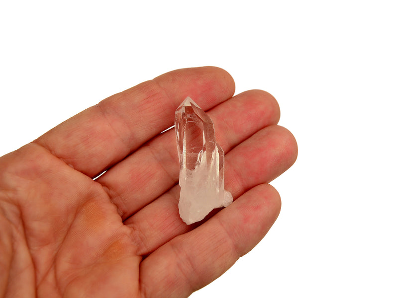 One mini rock crystal cluster on hand with white background