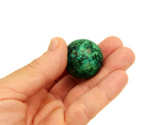 One chrysocolla sphere crystal 30mm on hand with white background