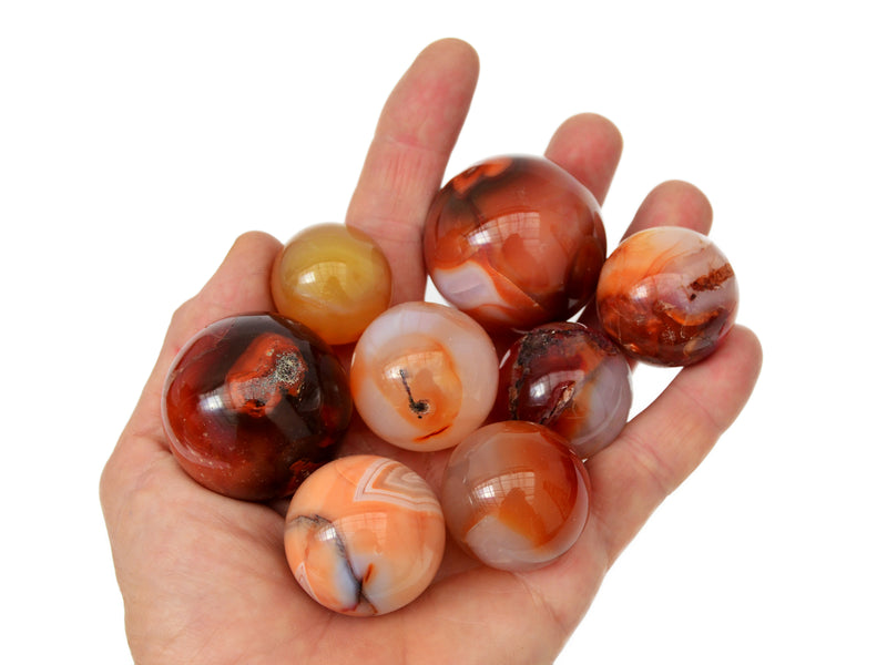 Some carnelian crystal balls 25mm-40mm on hand with white background