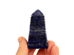 One blue lapis lazuli obelisk crystal 70mm on hand with white background