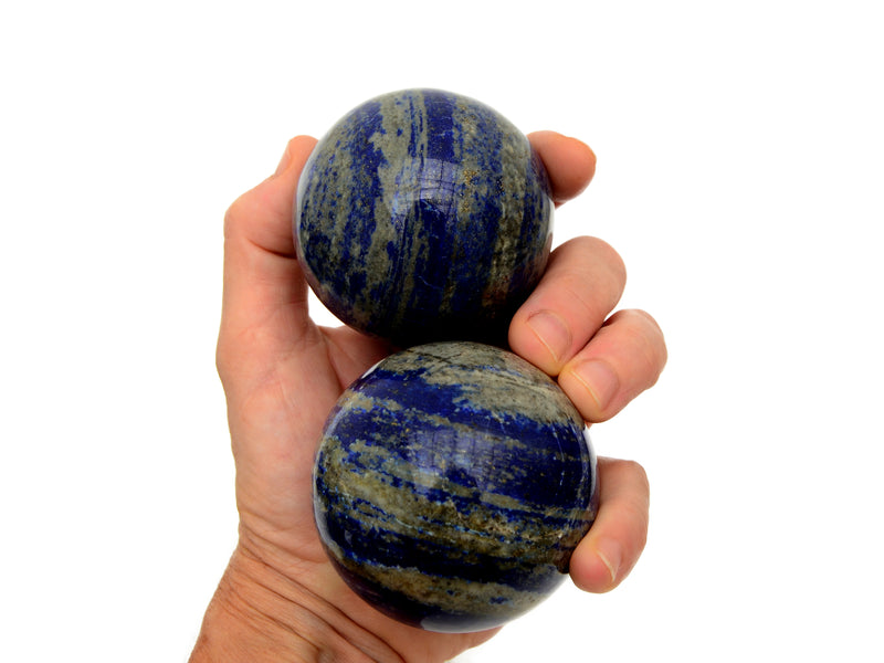 Two lapis lazuli spheres 70mm-75mm on hand with white background