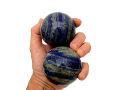 Two lapis lazuli spheres 70mm-75mm on hand with white background