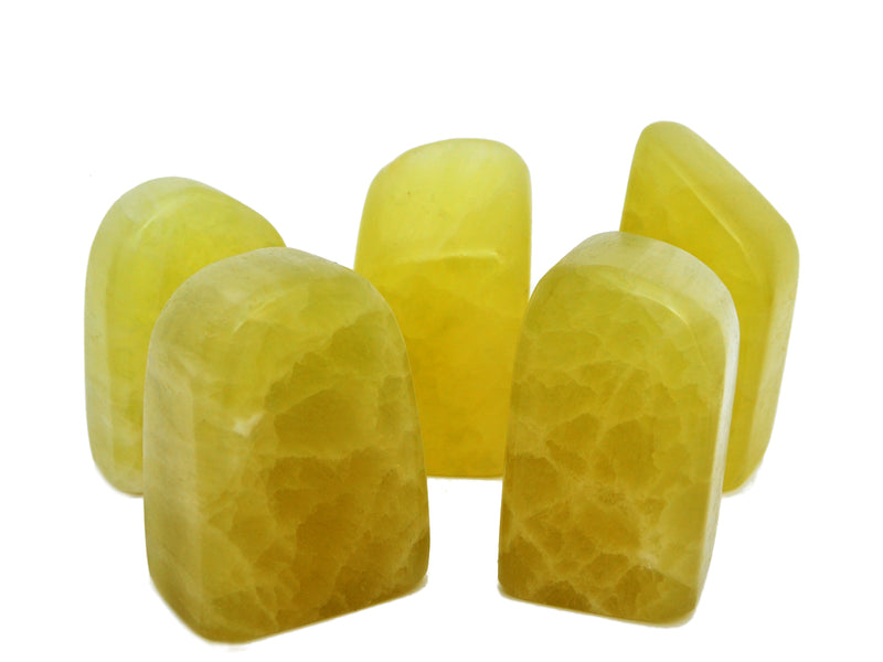 Five large lemon calcite free form stones 90mm-130mm on white background