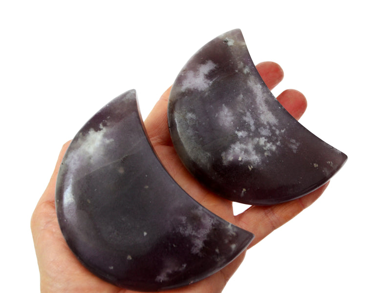 Two large lepidolite moon stones 90mm on hand with white background