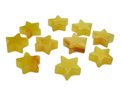 Several yelloc calcite star carved stones 55mm on white background