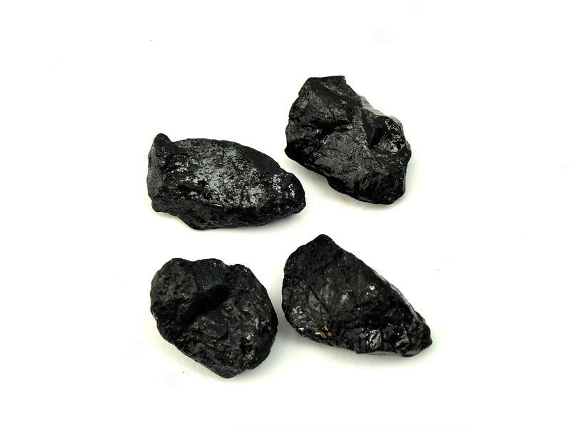 Four raw black tourmaline minerals 20mm-55mm on white background