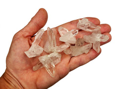 Some mini rock crystal clusters 30mm-40mm on hand with white background