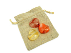 Carnelian, fire quartz and golden healer quartz hearts 30mm on small natural jute bag
