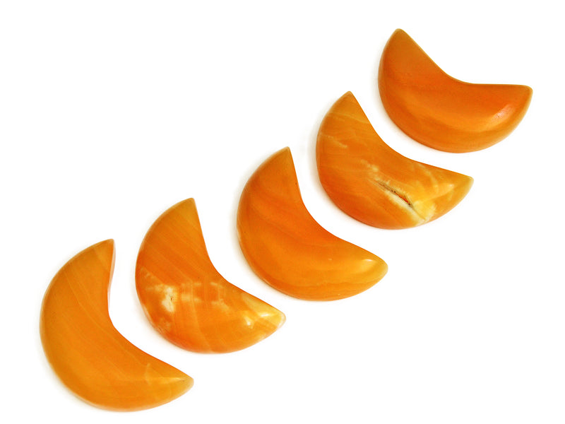 Five orange calcite moon stones 80mm-85mm on white background