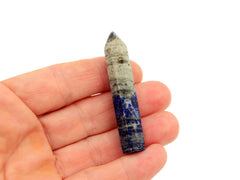 One small lapis lazuli crystal point 55mm on hand with white background