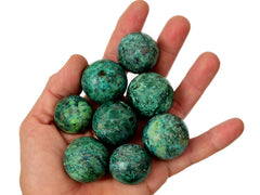 Some chrysocolla sphere crystals 25mm - 30mm on hand with white background