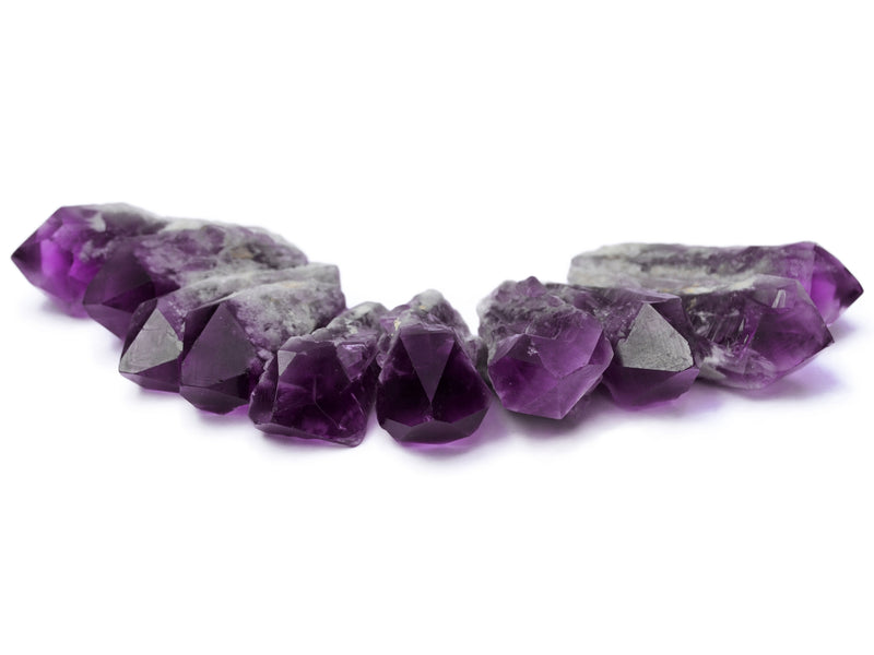 Some raw elestial amethyst points 60mm on white background