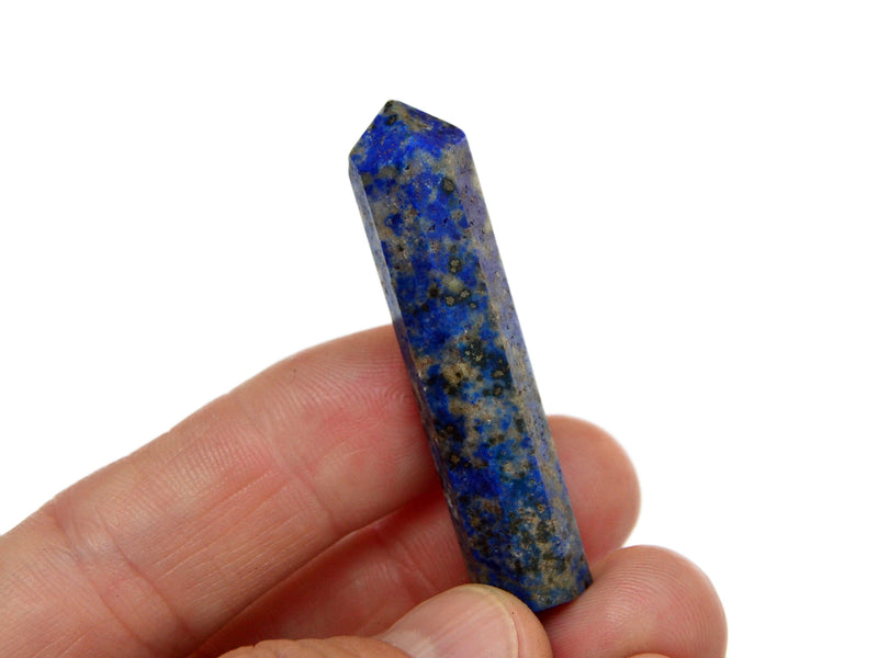 One lapis lazuli crystal point 50mm on hand with white background