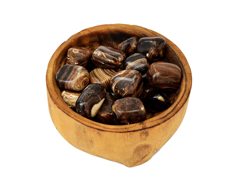 Some chocolate calcite mini tubled minerals inside a wood bowl on white background