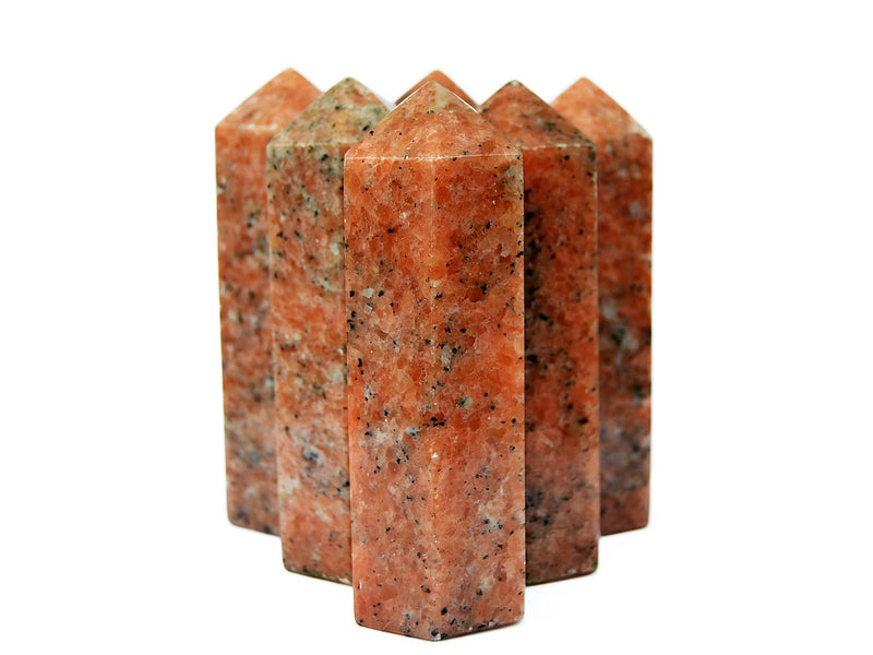 Some orange calcite crystal obelisks 110mm on white background