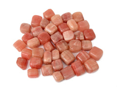 Several rose calcite mini tumbled crystals 20mm-30mm on white background