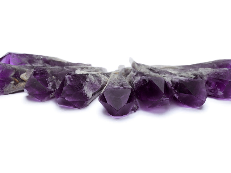 Some purple elestial amethyst roungh points 60mm on white background