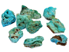 Several rough blue aragonite stones on white background