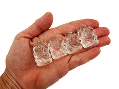 Four mini clear quartz ganesha sculpture 30mm on hand with white background