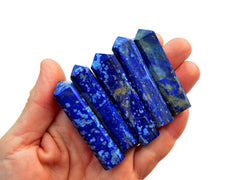 Five lapis lazuli tower points 55mm-65mm on hand with white background