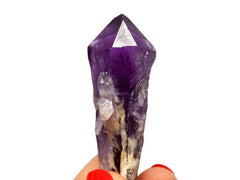 One raw elestial amethyst point 70mm on hand with white background