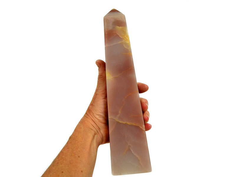 Reverse of extra large pink banded obelisk 250mm on hand with white background