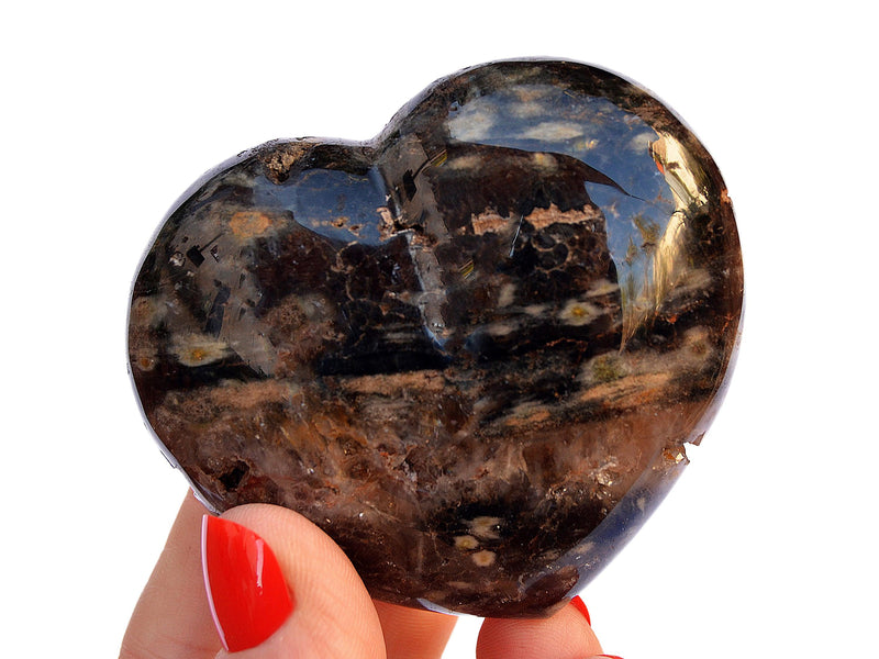 One big ocean jasper carved heart mineral 70mm on hand with white background