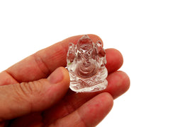 One mini clear quartz ganesha figure 30mm on hand with white background