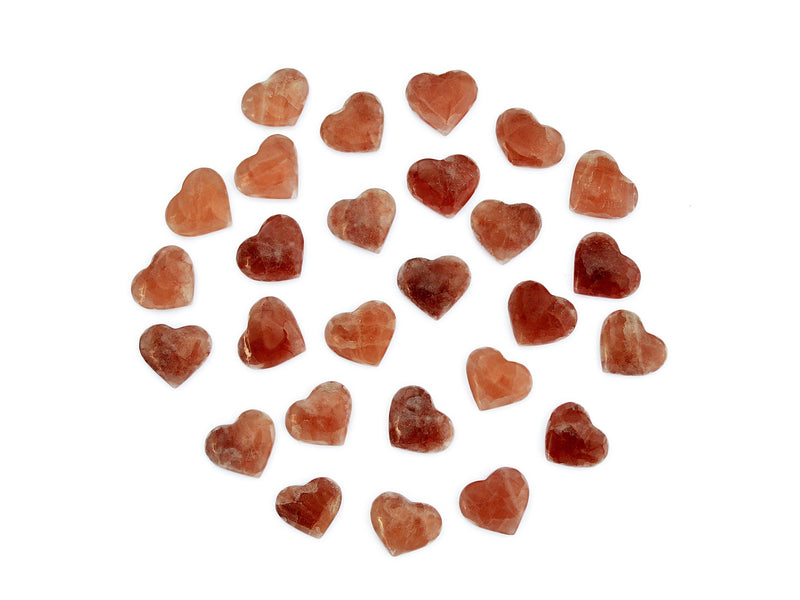 Several small rose calcite hearts 30mm-40mm on white background