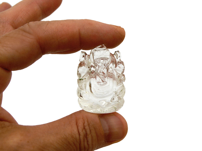 One mini clear quartz crystal ganesha sculpture 30mm on hand with white background