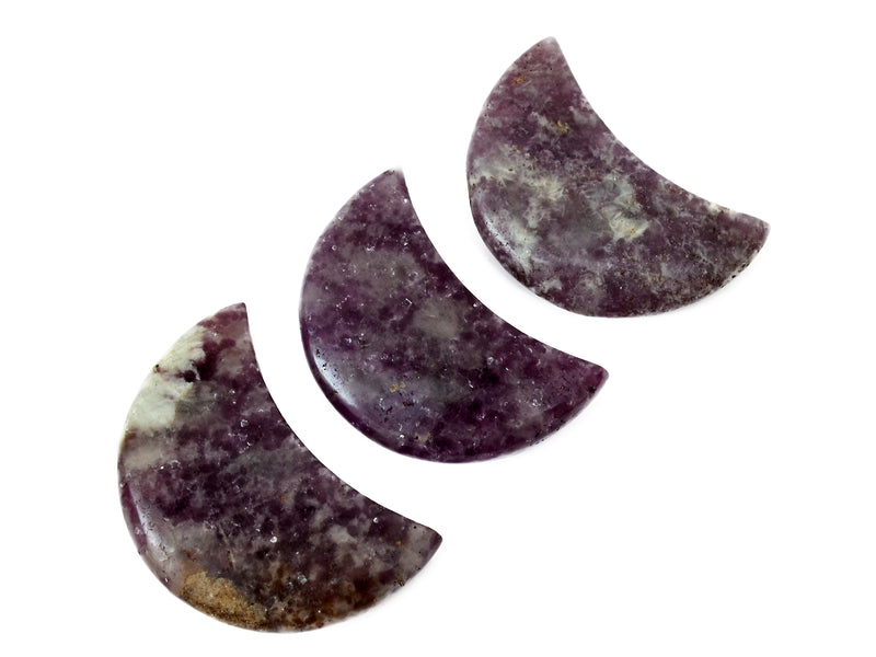 Three purple lepidolite moon carved crystals 90mm on white background