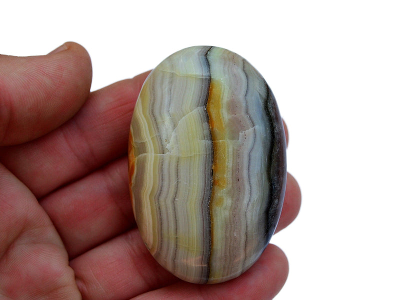 One pink banded onyx palm stone 70mm on hand with white background