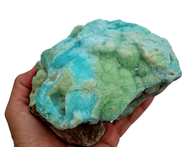 One big rough blue aragonite rock on hand with white background