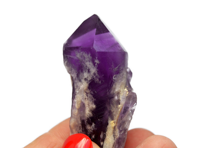 One rough elestial amethyst point 60mm on hand with white background