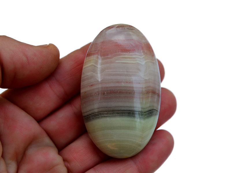 One pink banded onyx palm stone 50mm on hand with white background