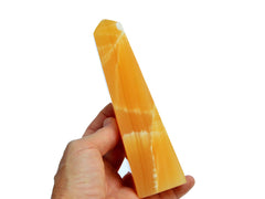 Orange Calcite crystal tower 160mm on hand with white background