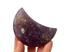 One purple lepidolite moon shaped crystal 85mm on hand with white background