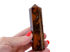 One brown ocean jasper tower crystal 90mm on hand with white background