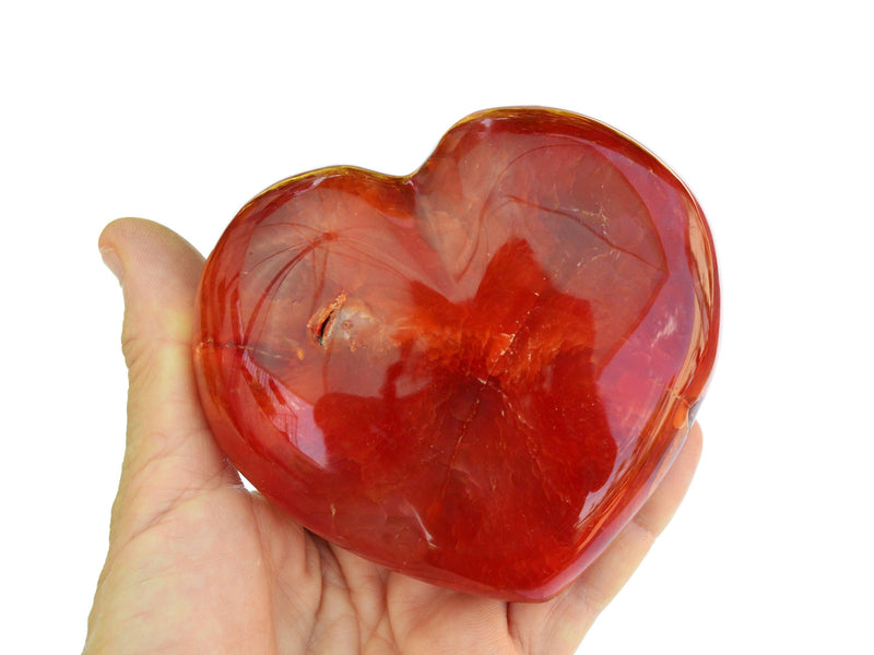 One big carnelian heart 90mm on hand with white background