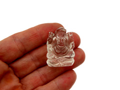 One mini clear quartz ganesha figure 30mm on hand with white background