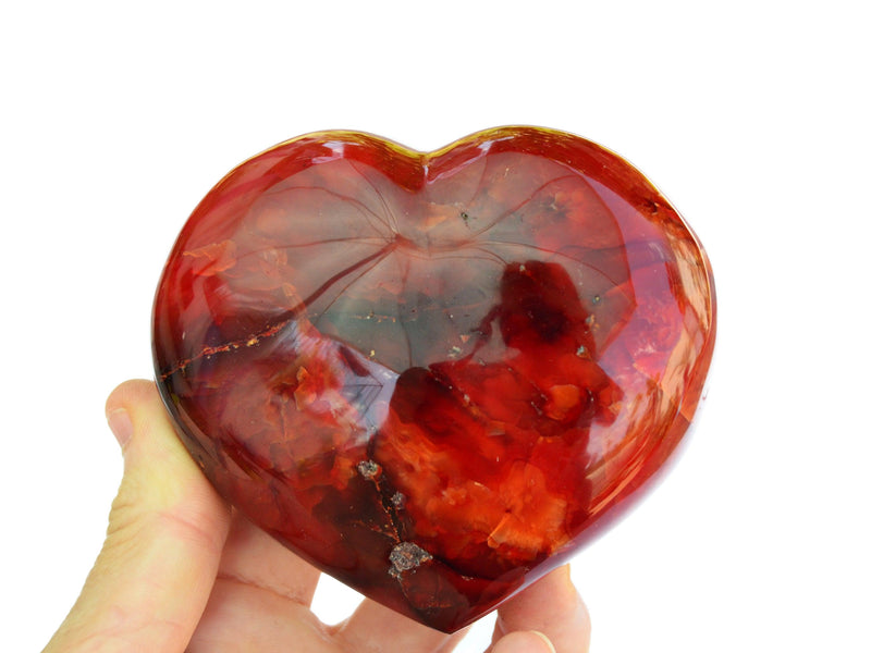 One extra large red carnelian heart crystal 100mm on hand with white background