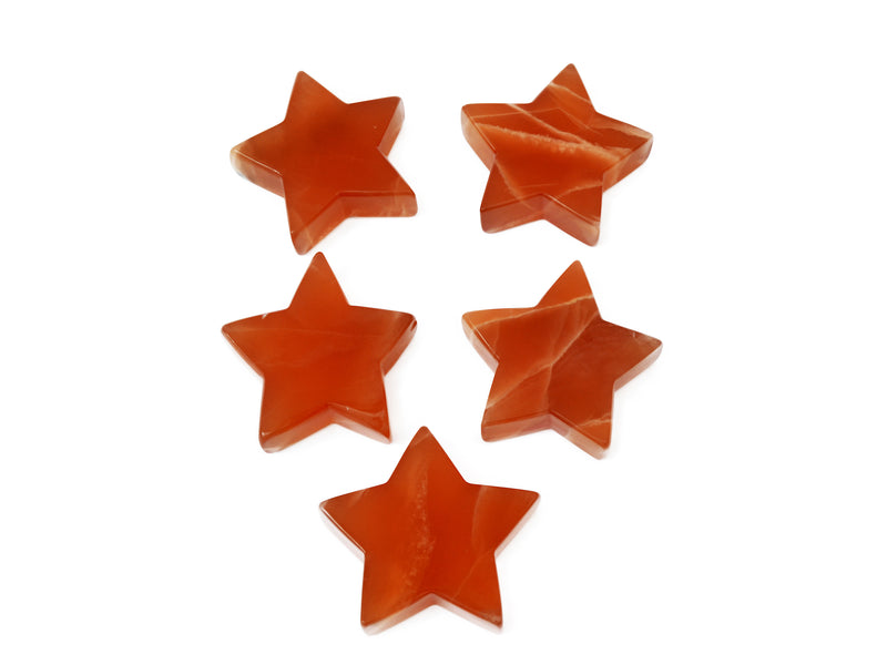 Five honey calcite carved stars 80mm on white background