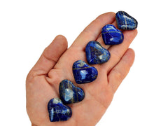 Six lapis lazuli crystal hearts 25mm-30mm on hand with white background