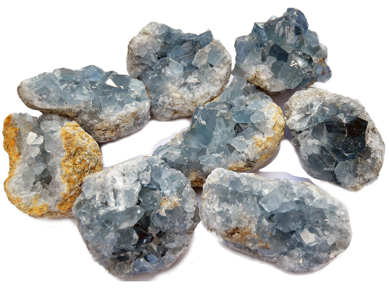 Some blue celestite crystal clusters on white background