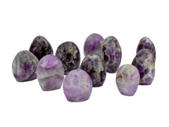 Some chevron amethyst free form crystals on white background