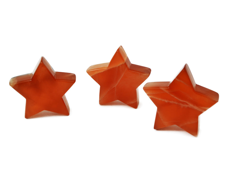 Three honey calcite carved stars 80mm on white background