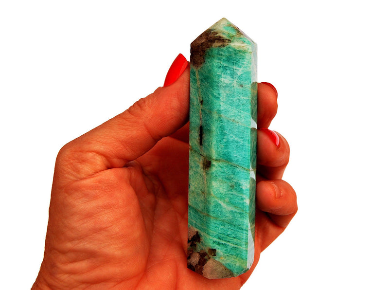Amazonite crystal point 95mm on hand with white background