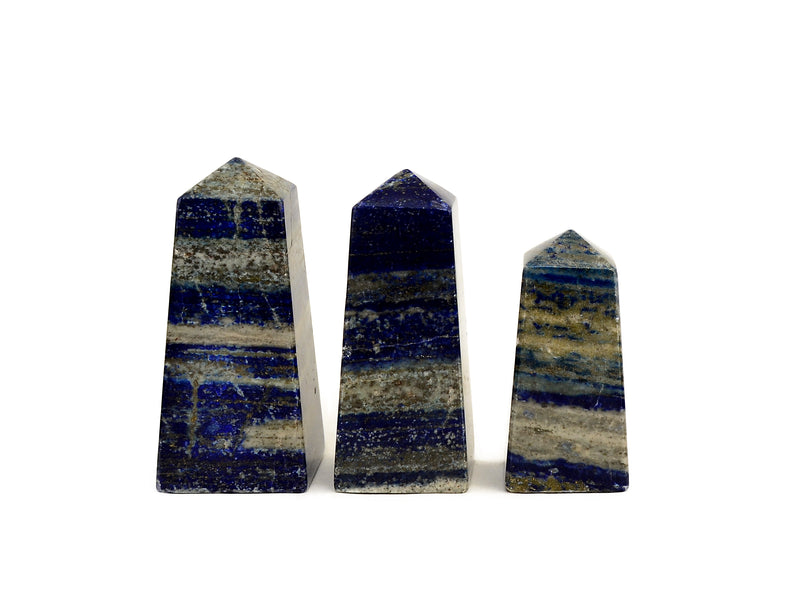 Three lapis lazuli crystal points on a white background