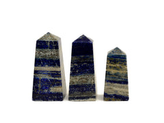 Three lapis lazuli crystal points on a white background